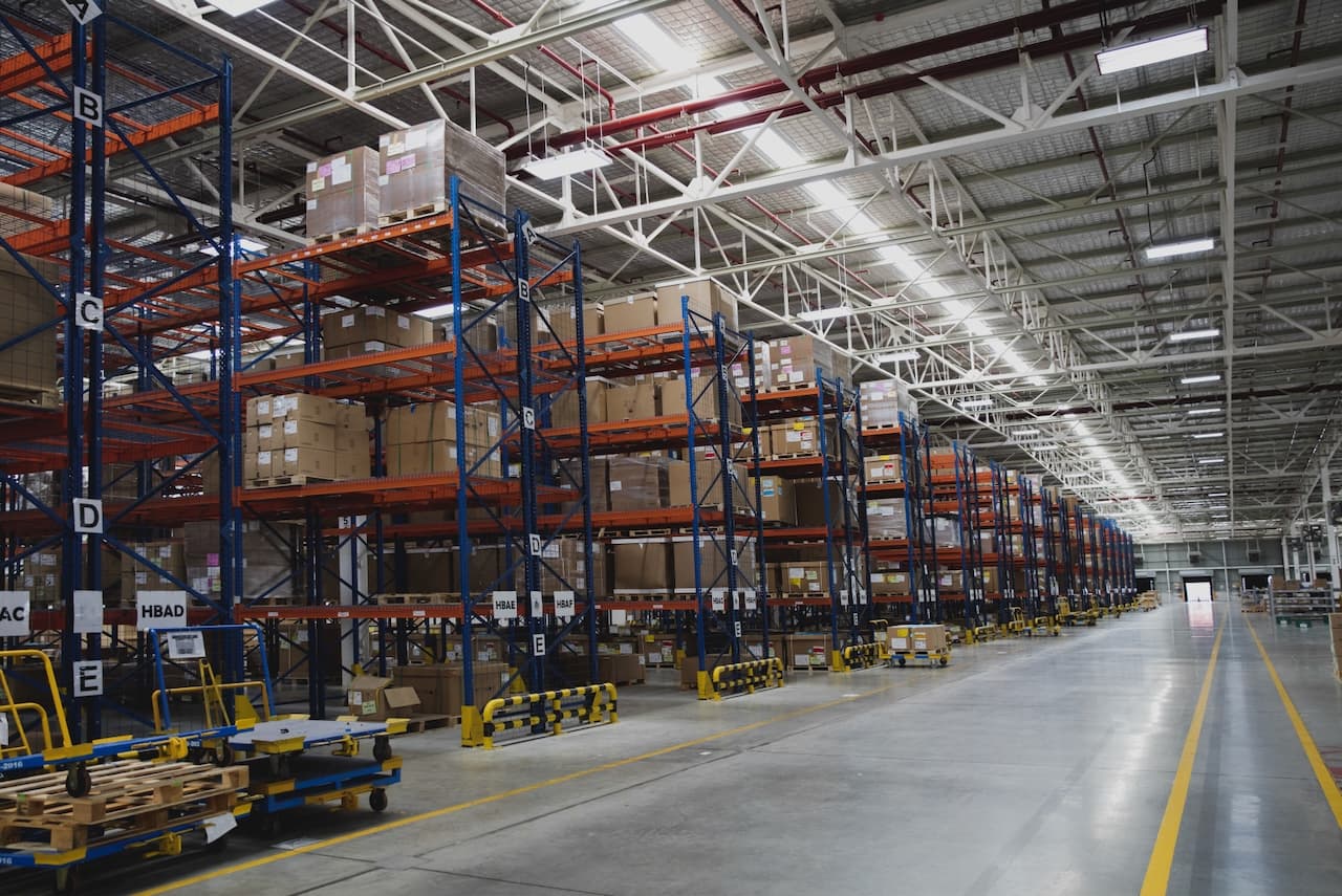 Spacious warehouse with shelves full of products, illustrating Del Bravo's storage and distribution capacity.