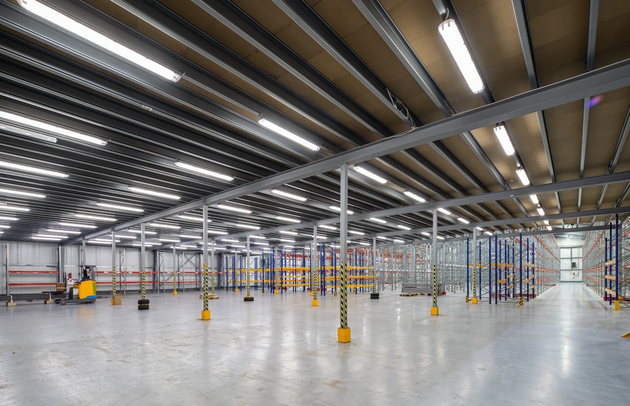 Empty warehouse with metal shelving ready for use, symbolizing Del Bravo's flexible and adaptable storage capacity