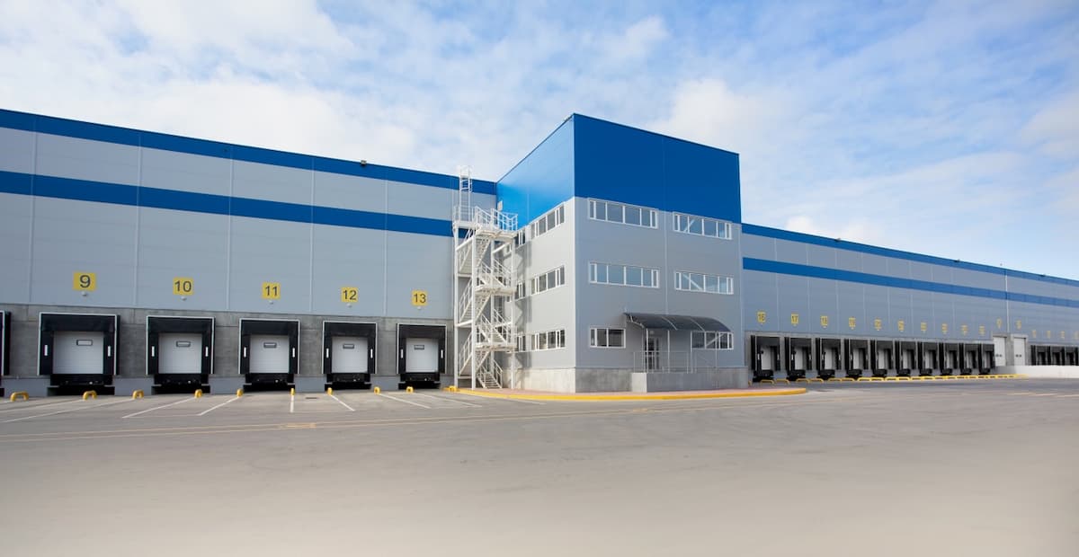 Modern warehouse facade with loading facilities, representing Del Bravo's advanced infrastructure for logistics and distribution