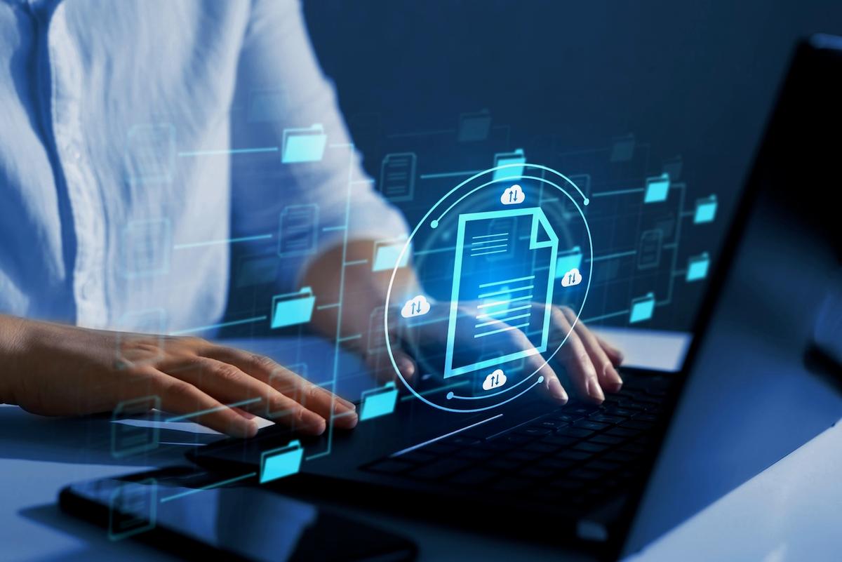 Hands typing on a keyboard with digital graphics representing documents in motion, symbolizing Del Bravo's efficiency and advanced technology in managing logistics documents