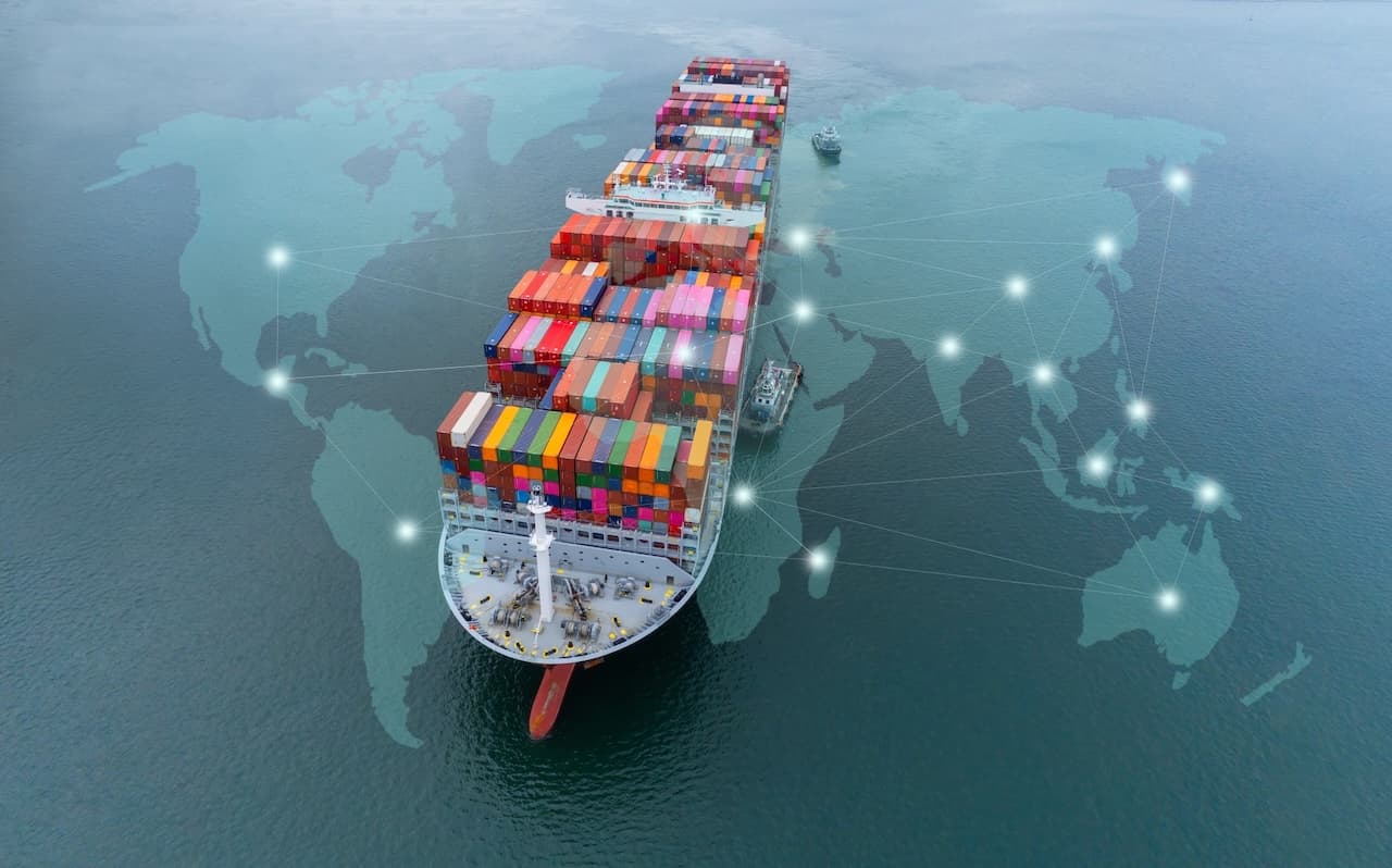 Cargo ship loaded with colorful containers sailing in Del Bravo’s global import and export operations.