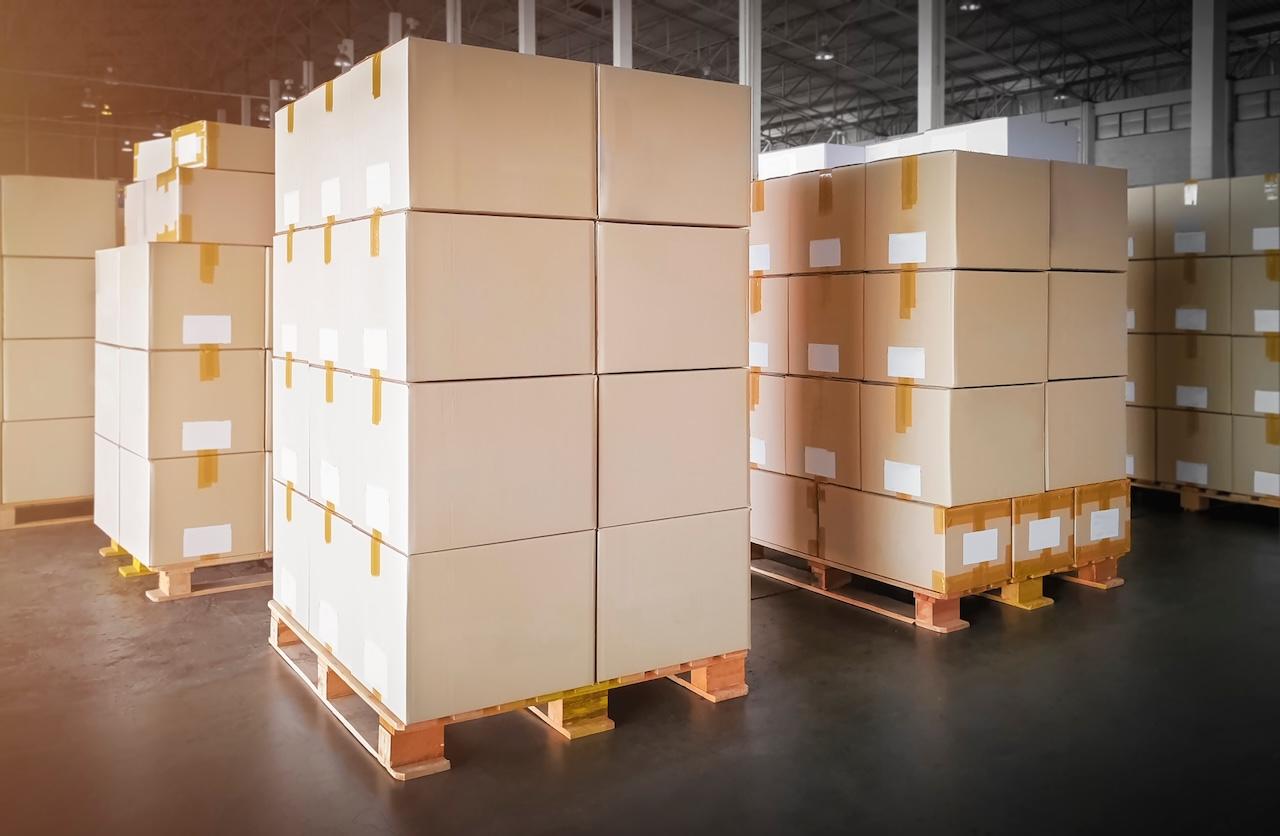 Stacked pallets with boxes in a Del Bravo warehouse, ready for shipment in logistics operations.