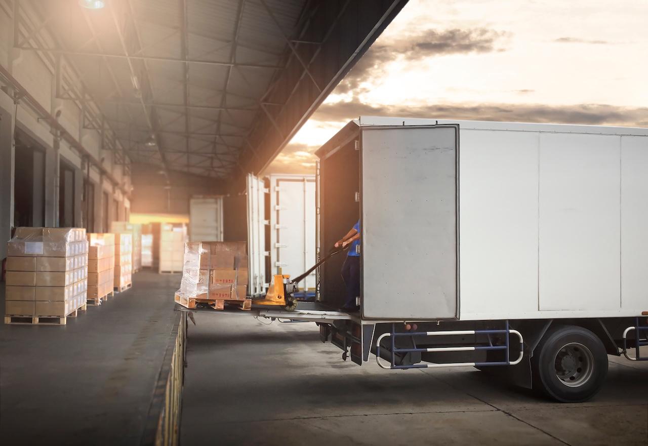 Del Bravo operator loading a truck with pallets at a loading dock, optimizing logistics operations.