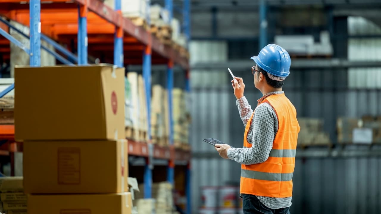Worker inspecting inventories in a warehouse managed by Del Bravo